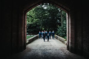 Groomsmen arriving at Peckforton Castle for wedding. Suits and sunglasses.