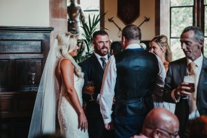 Bride and groom talking to guests at wedding reception