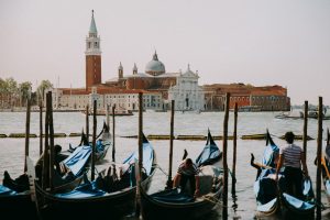 Moored gondolas bobbing on the water in Venice, as a wedding photographer it is a perfect backdrop for wedding photographs.