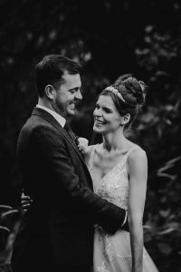 Black at white image of a bride and groom at The Granary Estates. They are facing each other smiling.
