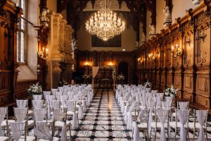 The ceremony room at Harlaxton Manor in Grantham. Chris laid out with white sash and green flowers.