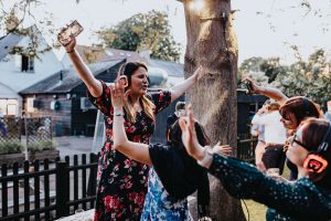 Wedding guests dancing to a silent disco. All wearing headphones.