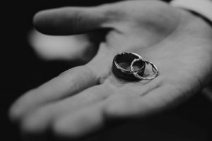 Close up image if a hang holding wedding rings