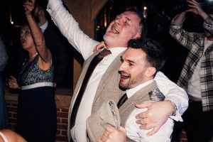 Father of the bride and the best man dancing at a wedding.