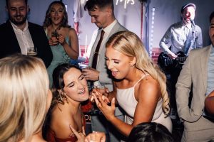 Bridesmaid and guests dancing on the dance floor.
