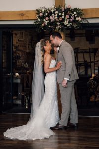 Bride and groom about to kiss at sissons Barn wedding venue